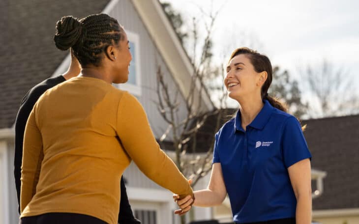 dominion energy solutions rep shaking hands with customer