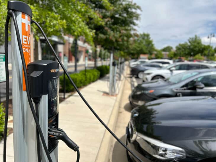 Row of commercial EV chargers in an outdoor parking lot